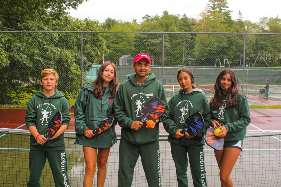 Campers with their rackets at the tennis courts