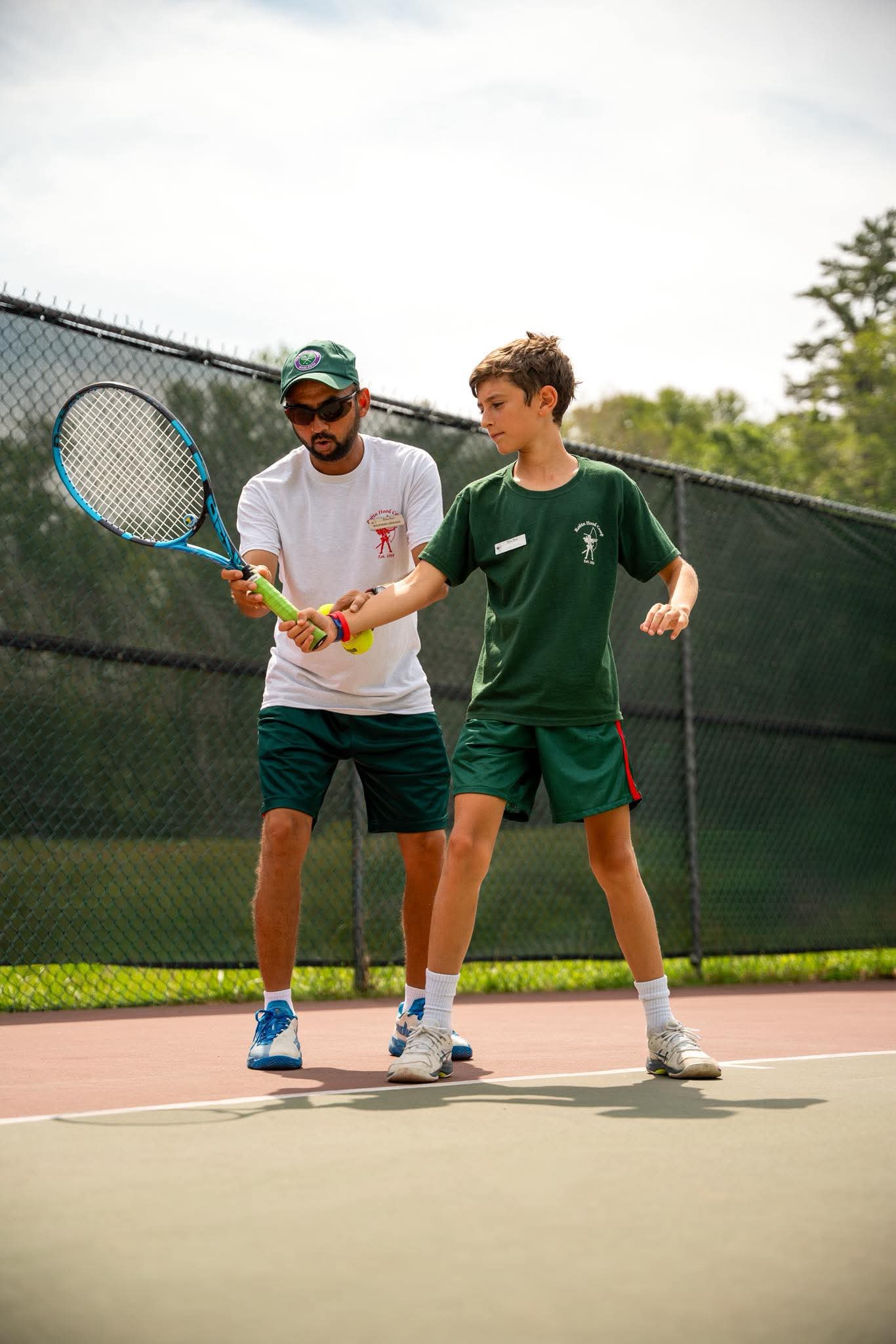 Coach Mahendra coaching a camper at Robin Hood Summer Camp