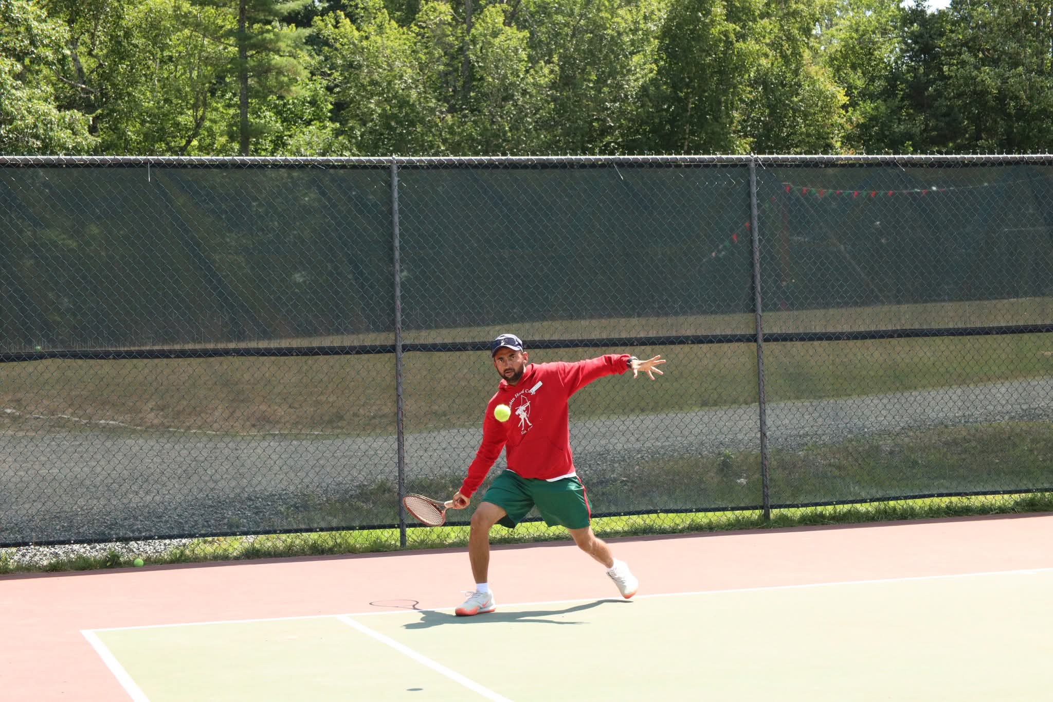 Player serving on the Robin Hood Summer Camp courts