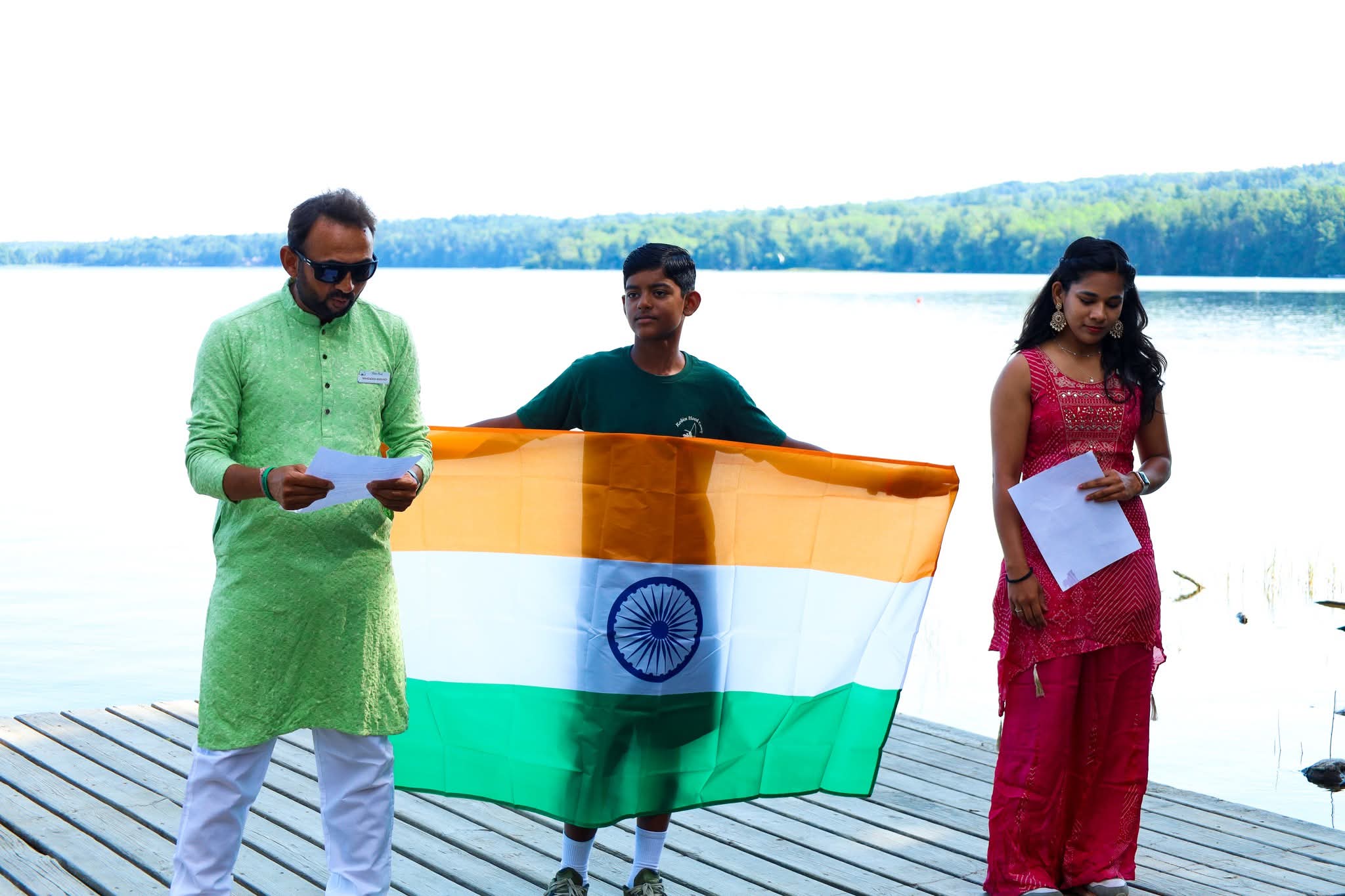 Flag ceremony by the lake at Robin Hood Summer Camp
